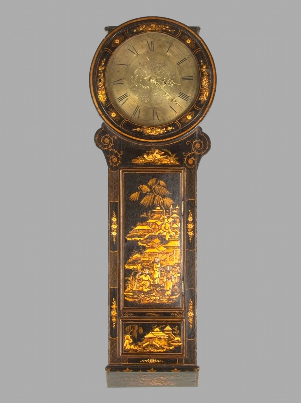 An eighteenth-century black lacquered clock decorated with gilded Chinoiserie scenes and an engraved circular brass dial.