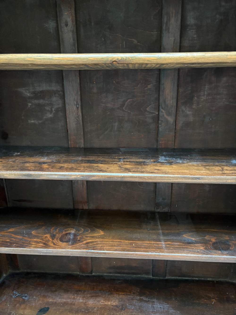 An upright rectangular wooden bookcase featuring four open tiers, fluted pilasters on the sides, and a projecting top cornice. View III