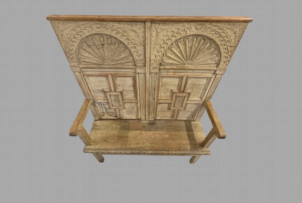 A high-backed wooden settle featuring a limed grey finish, carved lunette arches, geometric panels, and flat armrests. View III