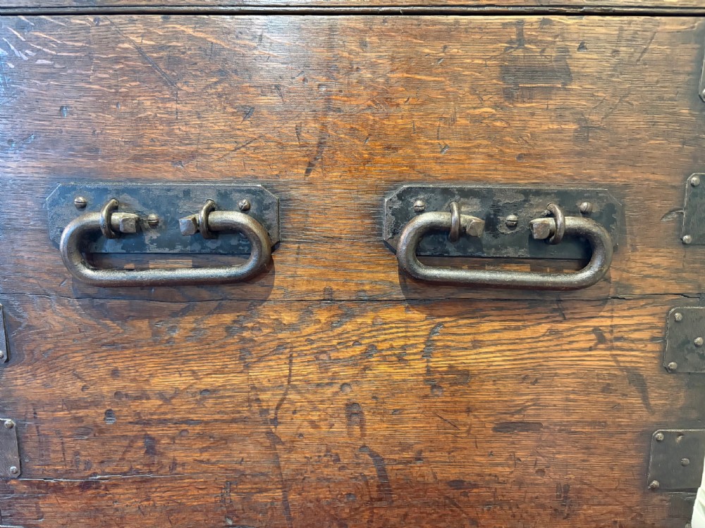 A Victorian oak silver chest reinforced with dark riveted iron straps, metal corner brackets, and a central locking mechanism. View VII