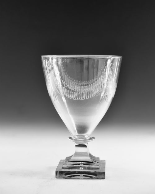 fig 1. A Georgian clear glass rummer featuring an engraved festoon bowl on a square mould-pressed pedestal base.