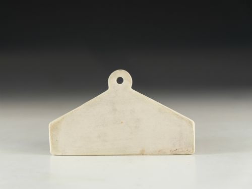 fig 2. A mid-19th-century white ceramic wine bin label with a top mounting hole, printed with the text MADEIRA in black capital letters.