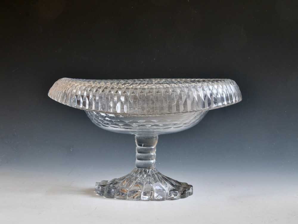 A late 18th-century clear cut glass pedestal bowl with a wide folded turnover rim, diamond cutting, and a heavy moulded foot.