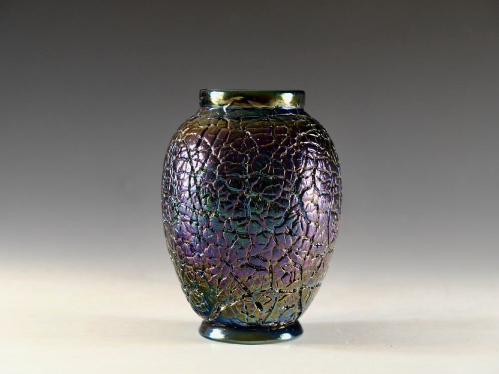 A Victorian iridescent bronze glass vase featuring a crackled textured surface with purple, green, and gold metallic hues.