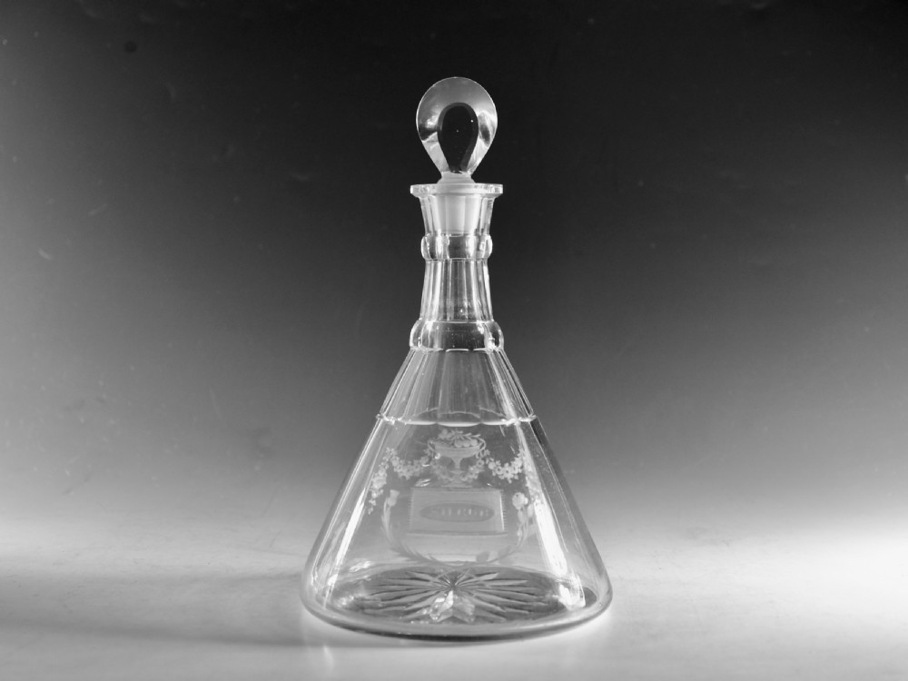 A clear Georgian cut glass ship decanter featuring a broad conical base, floral wheel engraving, a ringed neck, and a loop stopper. View II