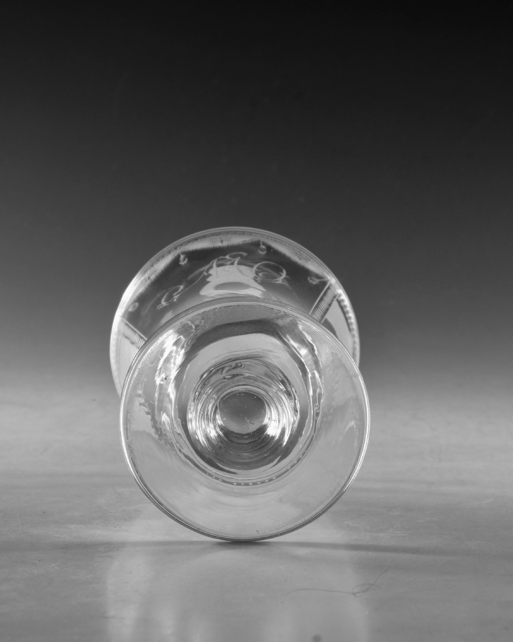 An antique clear lead glass rummer featuring detailed wheel engraving of a sailing ship beneath a bridge, set on a knopped stem and circular foot. View VIII