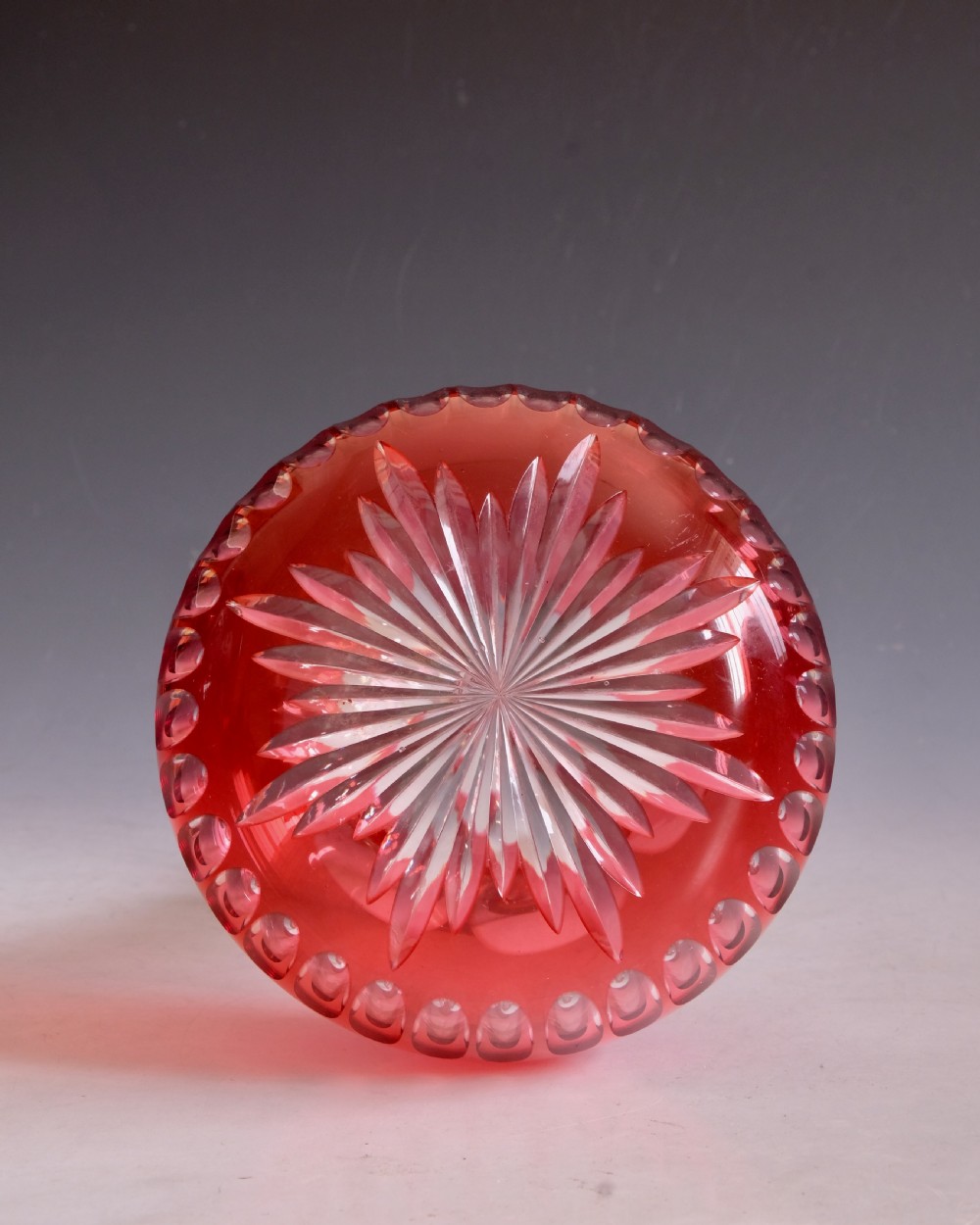 A mid-Victorian ruby overlay cut glass decanter with a matching faceted stopper and slice-cut neck. View IX