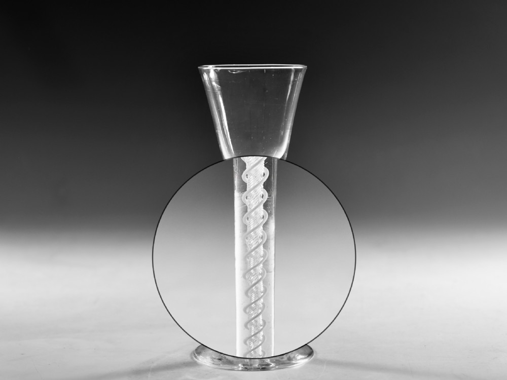 A clear Georgian lead crystal wine glass featuring a bell-shaped bowl, a mixed twist stem, and a circular conical foot. View VII
