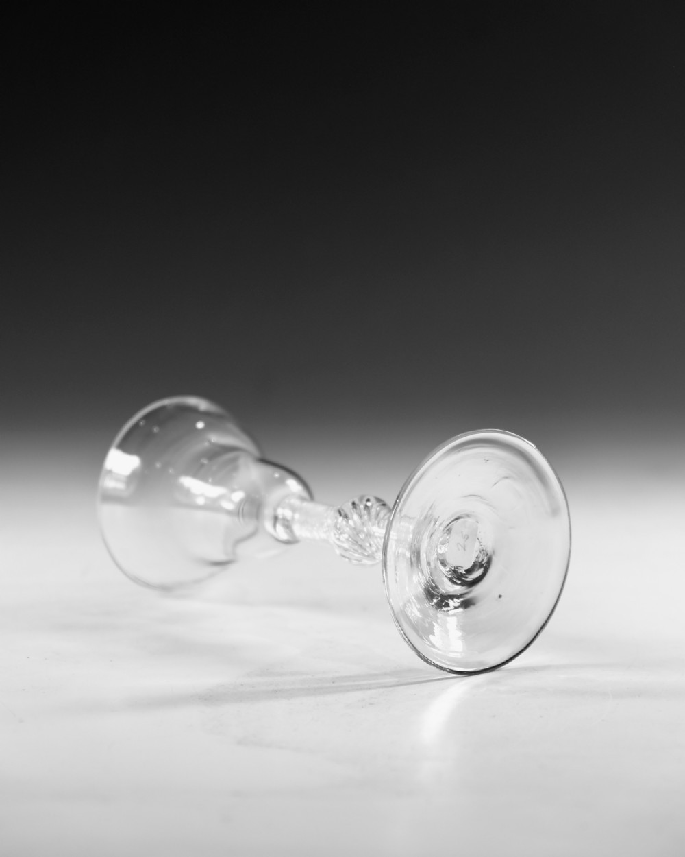 An 18th-century English clear lead glass wine glass featuring a flared bowl, a knopped stem with a multi-spiral air twist pattern, and a wide circular foot. View III