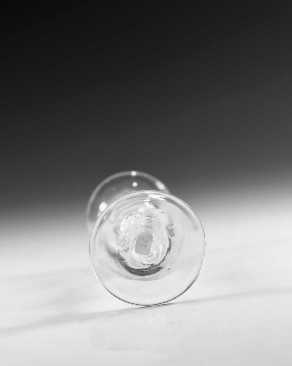 An 18th-century English clear lead glass wine glass featuring a flared bowl, a knopped stem with a multi-spiral air twist pattern, and a wide circular foot. View VI