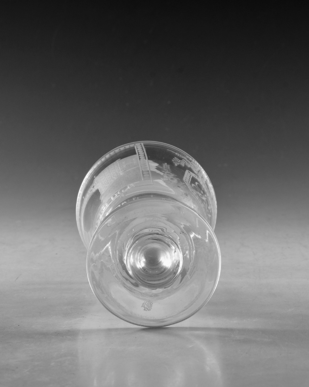 An antique clear glass rummer featuring detailed wheel engraving of a sailing ship beneath the Wearmouth Sunderland Bridge, supported by a knopped stem and circular foot. View VIII