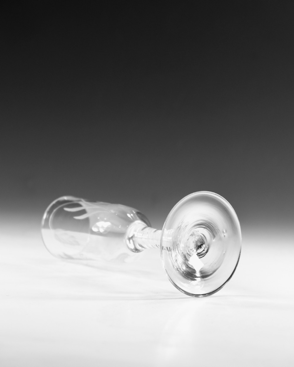 An eighteenth-century lead glass ale flute featuring an engraved hops and barley motif on an elongated bowl, resting upon a double series opaque twist stem and a conical foot. View IV