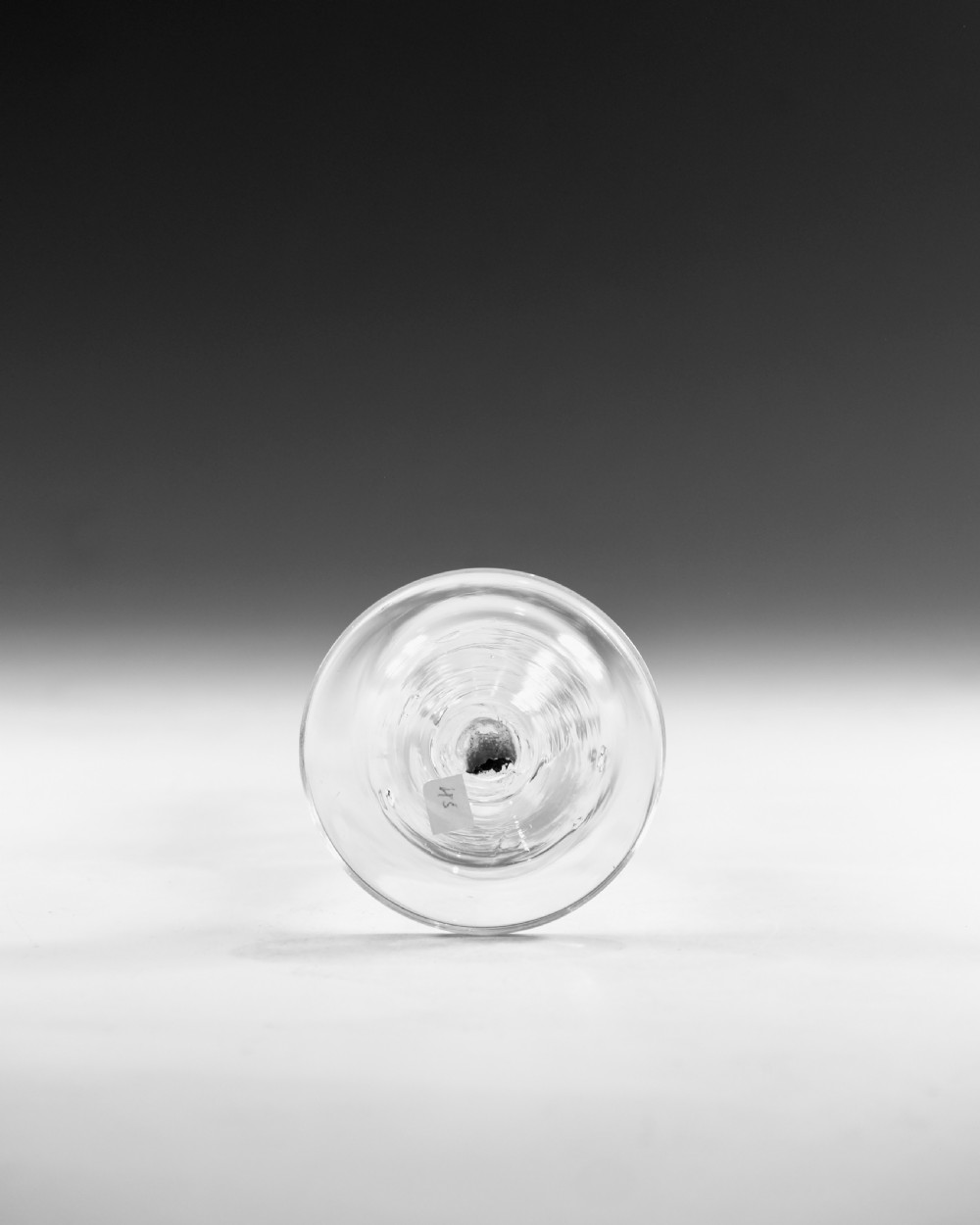 An eighteenth-century lead glass ale flute featuring an engraved hops and barley motif on an elongated bowl, resting upon a double series opaque twist stem and a conical foot. View VI