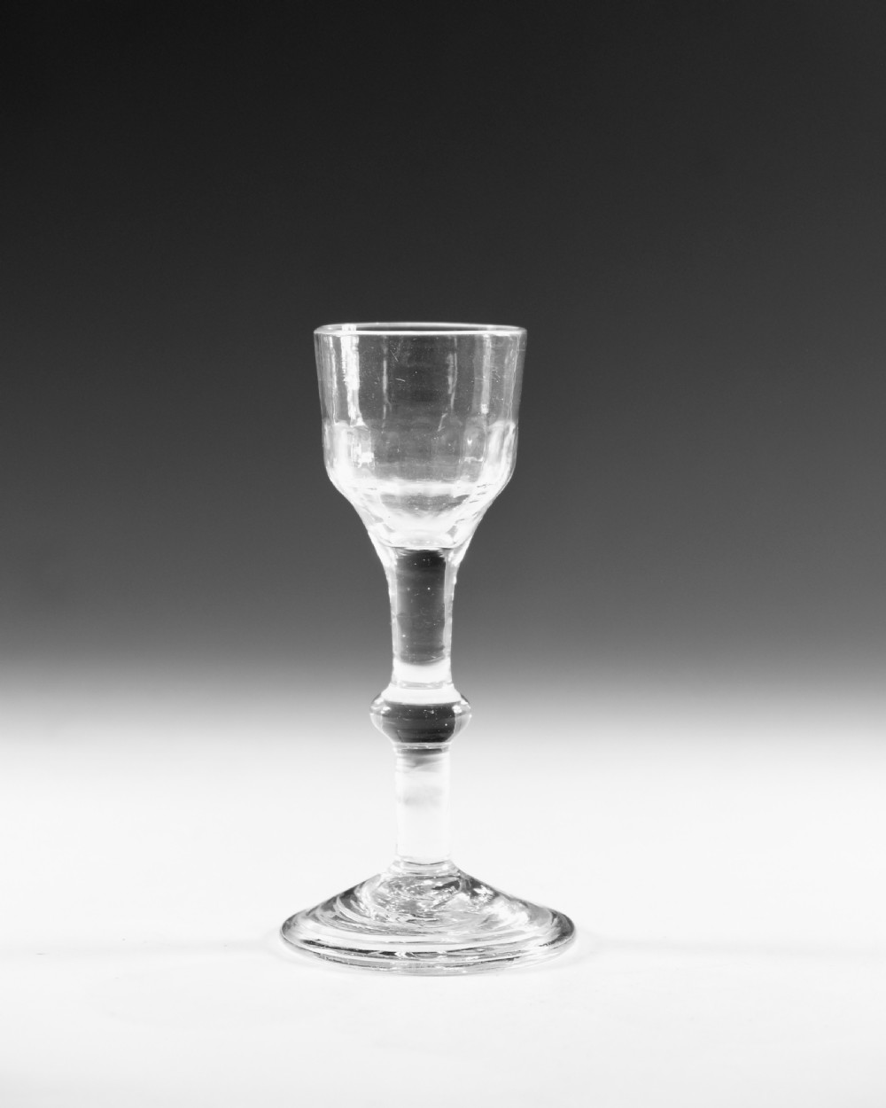 A clear Georgian balustroid wine glass featuring a stem with a central knop resting on a circular foot. View II