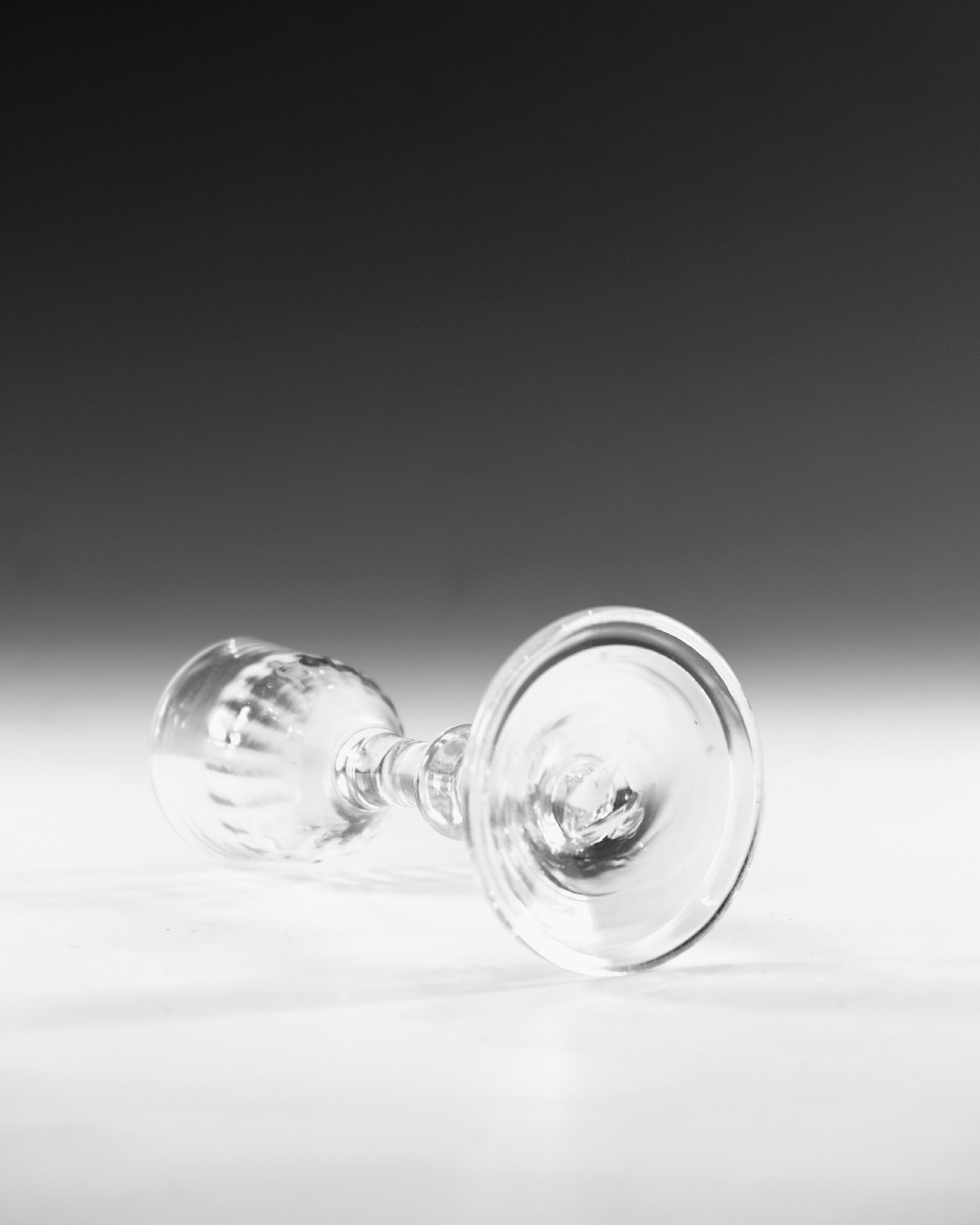 A clear Georgian balustroid wine glass featuring a stem with a central knop resting on a circular foot. View III