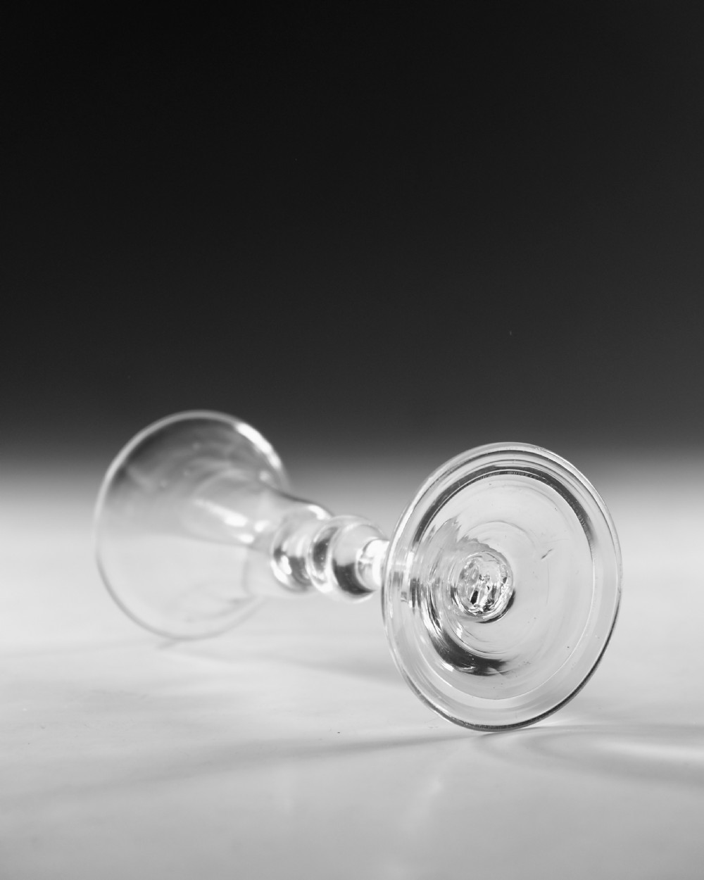 A Georgian clear glass wine glass featuring a flared bell bowl, a knopped stem, and a circular conical foot. View III