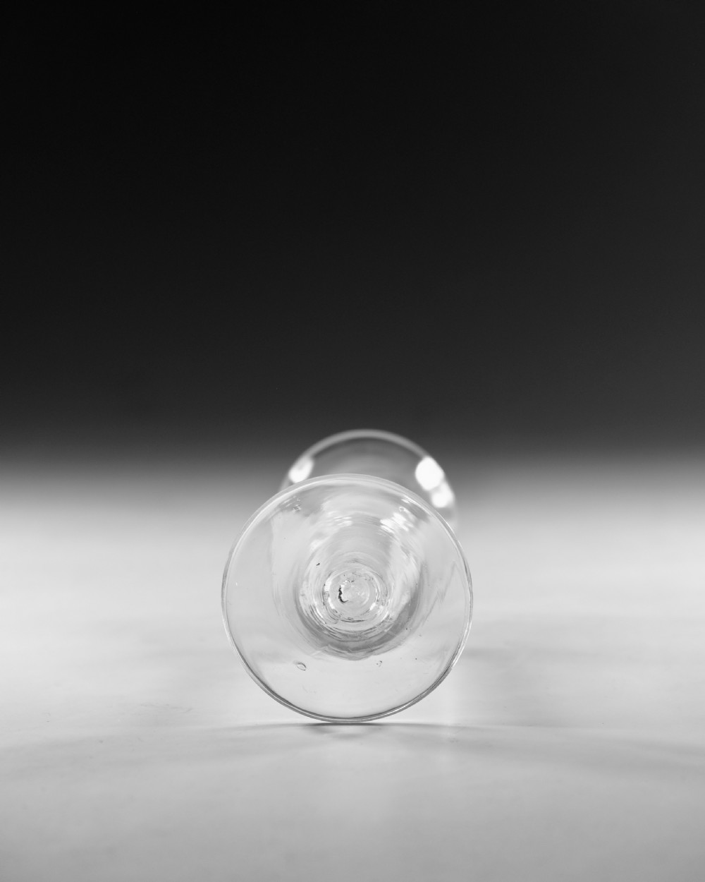 A Georgian clear glass wine goblet with a flared bell bowl and an opaque white spiral twist stem on a circular conical foot. View V