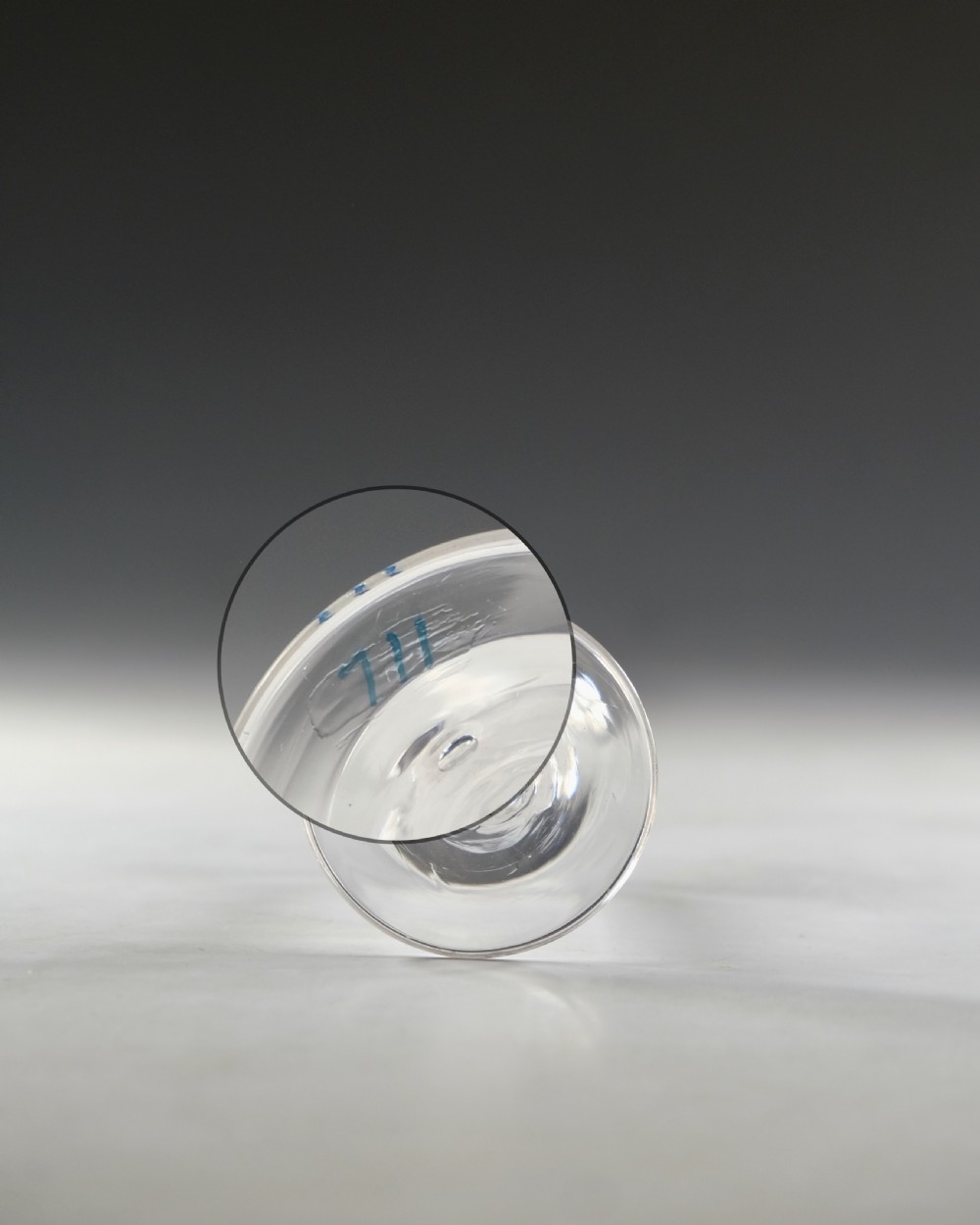 An 18th-century clear glass wine glass featuring an internal white opaque twist stem and a wide conical foot. View VII