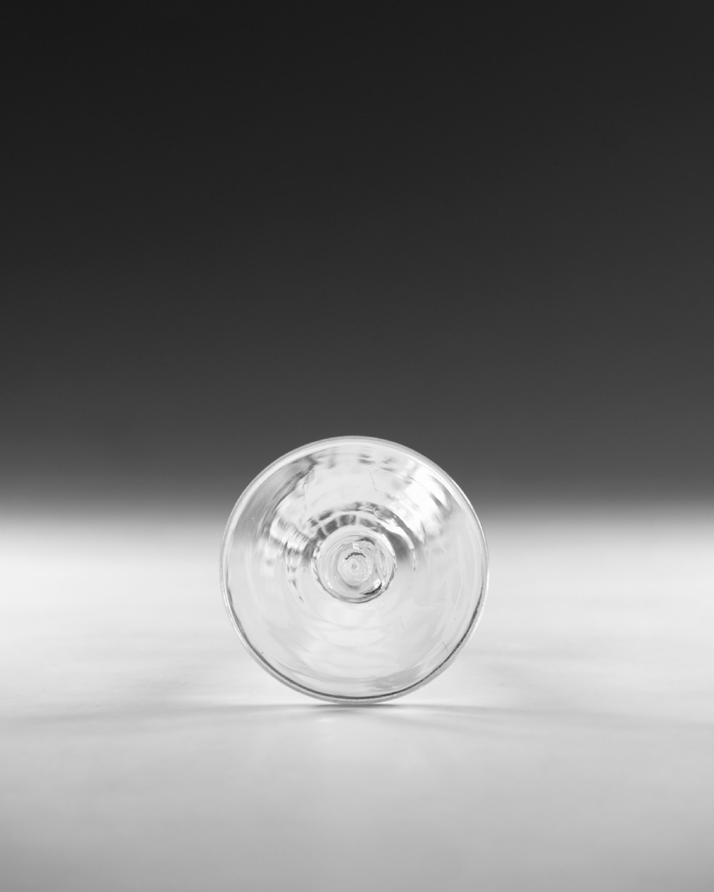 An eighteenth-century clear lead glass wine glass featuring an internal opaque white spiral twist within the stem and a conical foot. View VI