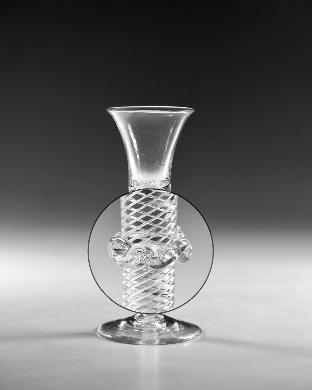 An 18th-century clear glass wine vessel featuring a flared bell bowl, an intricate air-twist stem with a central knop, and a flat conical base. View III