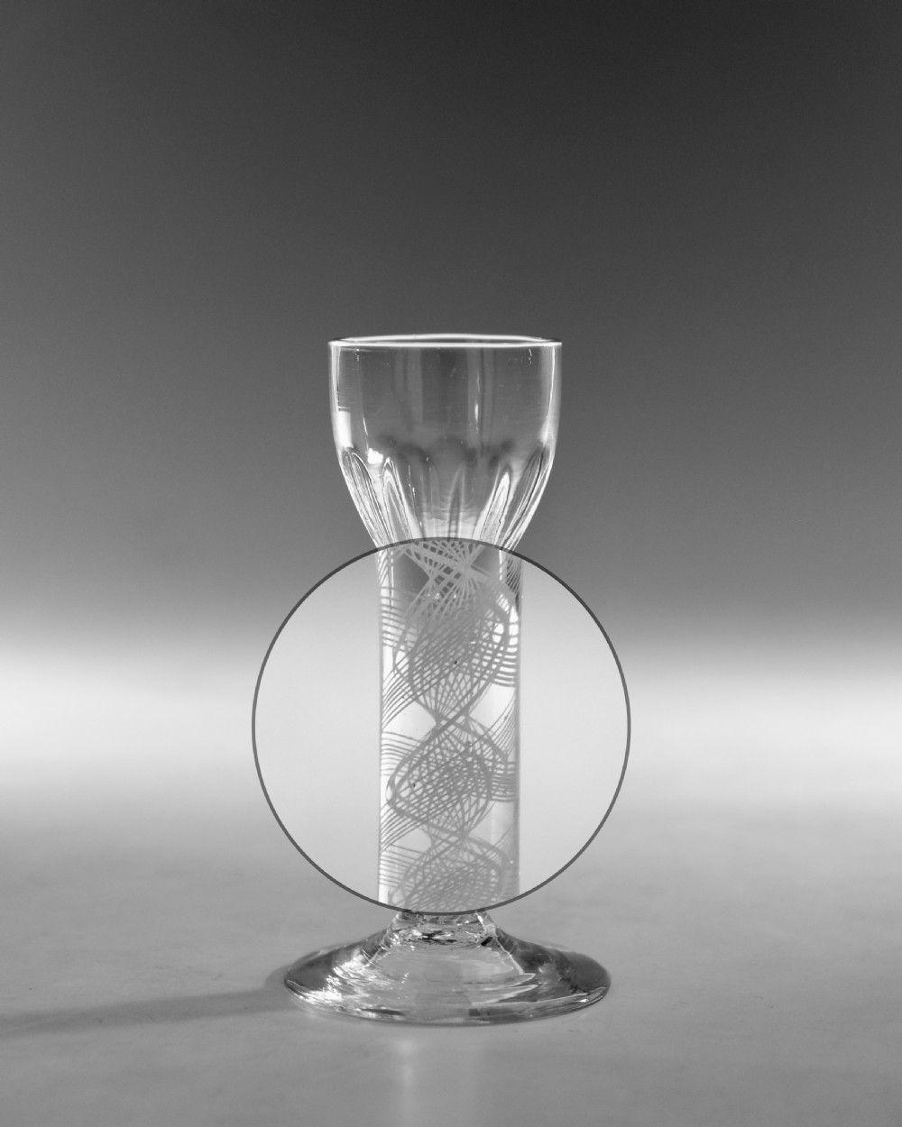 An 18th-century clear glass wine vessel featuring a rounded fluted bowl, an opaque white twist stem, and a conical foot. View III
