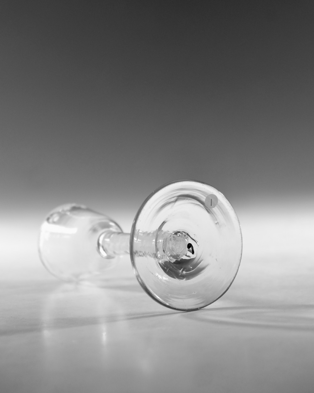 An 18th-century Georgian clear lead glass wine glass featuring an engraved bowl rim, an opaque twist stem, and a circular conical foot. View III
