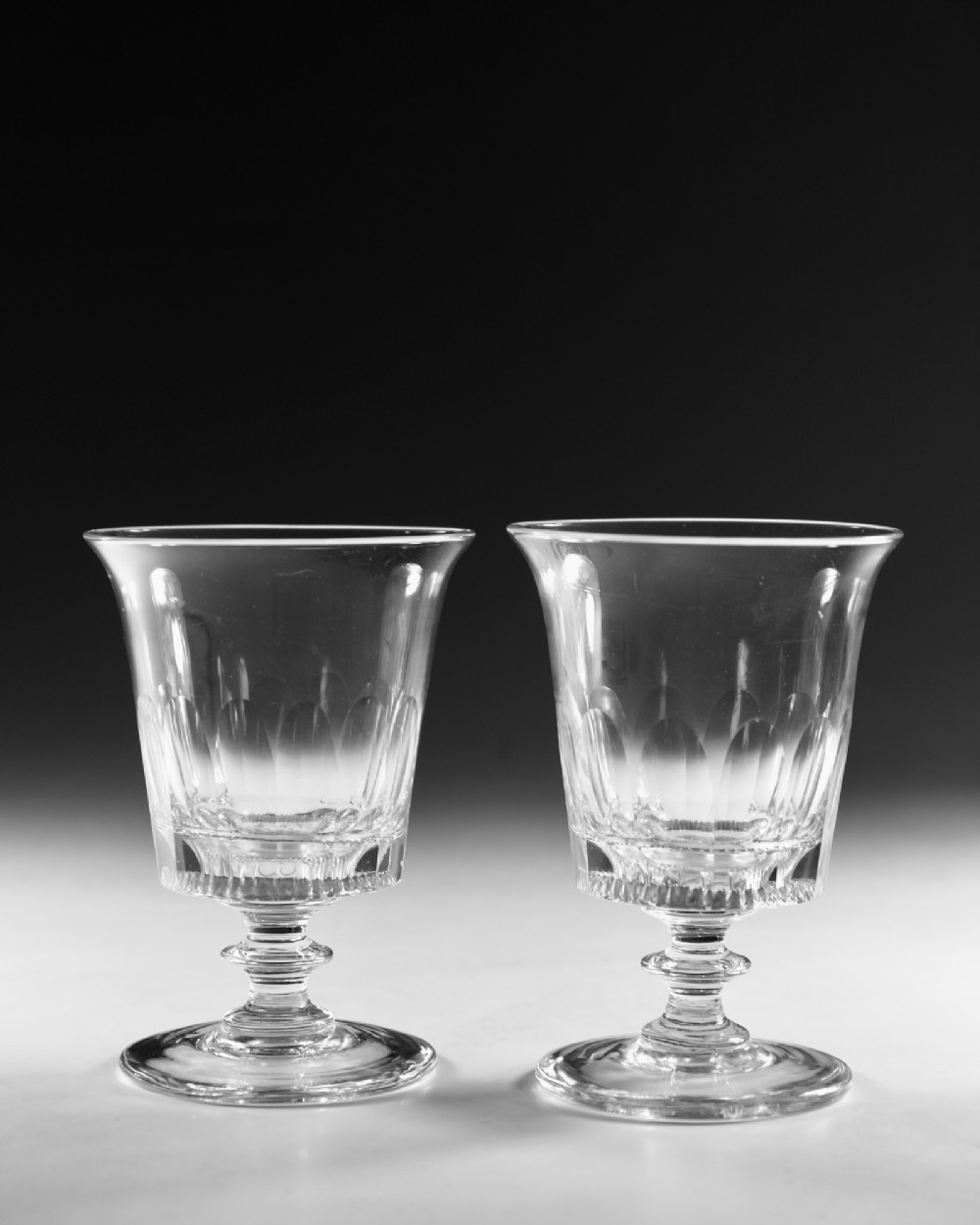 A set of six English Georgian clear glass rummers with cut fluted bowls and knopped stems on circular bases. View V