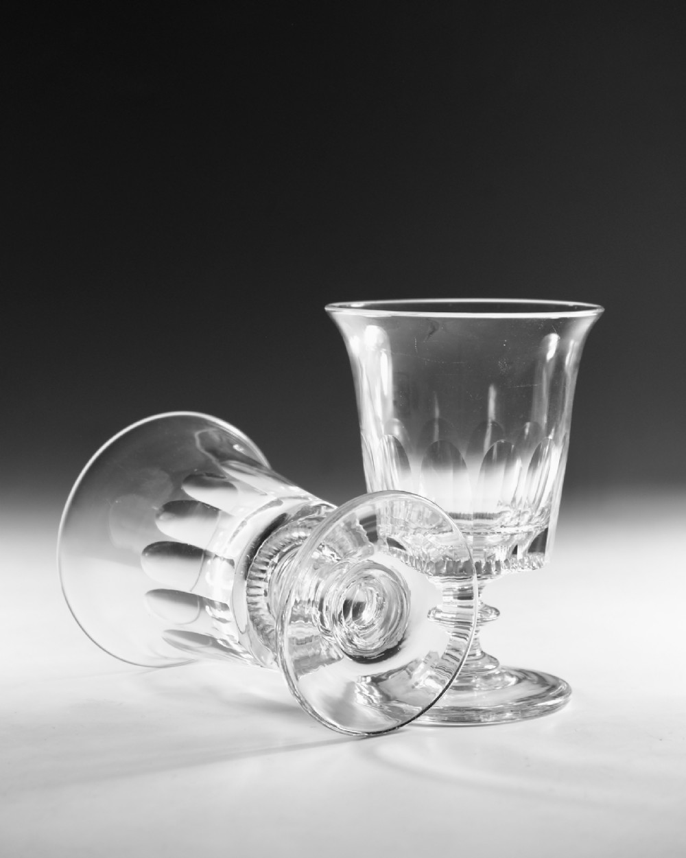 A set of six English Georgian clear glass rummers with cut fluted bowls and knopped stems on circular bases. View VI