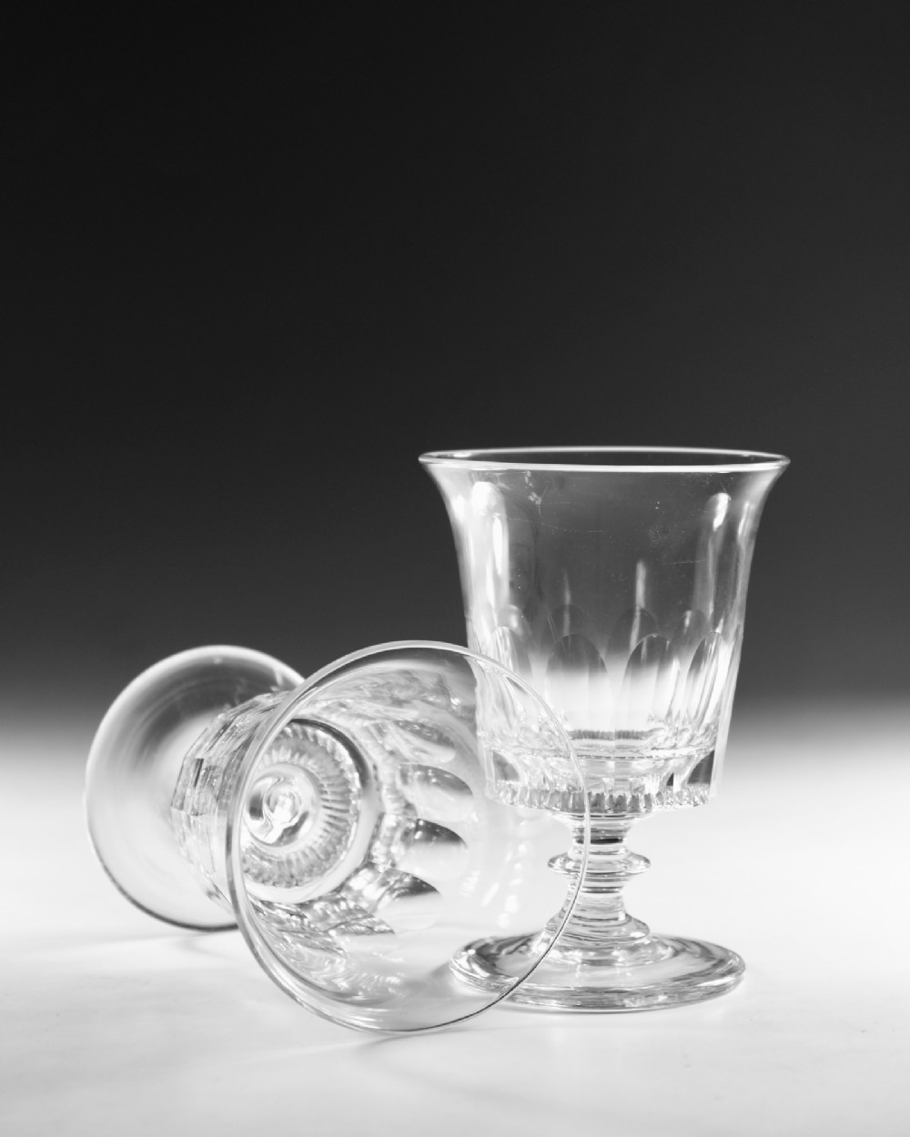 A set of six English Georgian clear glass rummers with cut fluted bowls and knopped stems on circular bases. View VII