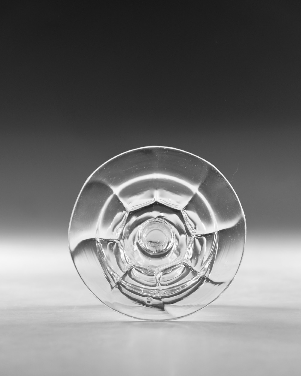 An eighteenth-century Georgian clear lead glass patch stand featuring a shallow rimmed top, a multi-knopped baluster stem, and a circular folded foot. View III