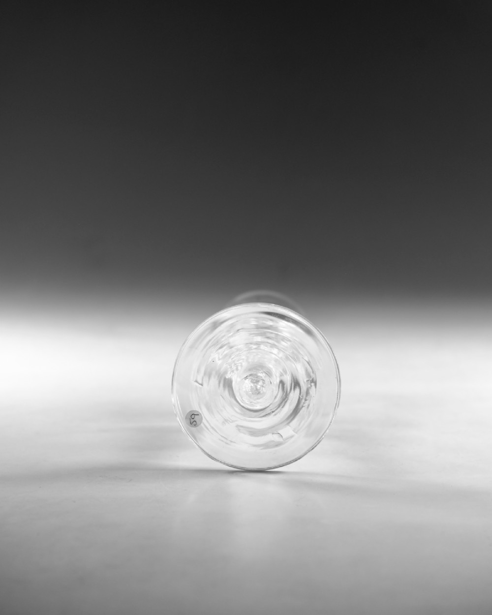 A Georgian clear glass ale flute with a tall bowl, knopped air twist stem, and a flat conical base. View V