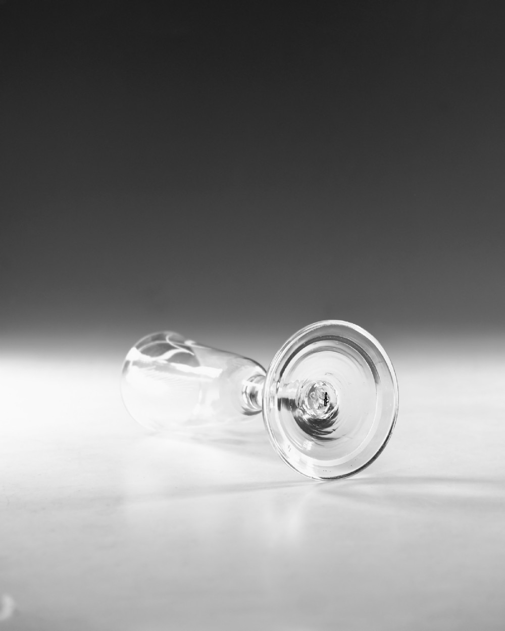 A tall Georgian clear glass ale flute with an engraved hop and barley motif, a straight plain stem, and a flat conical base. View IV