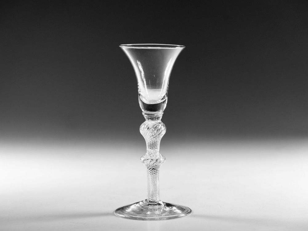 A clear hand-blown Georgian lead crystal wine glass featuring a bell-shaped bowl, a knopped air twist stem, and a broad conical foot. View VI