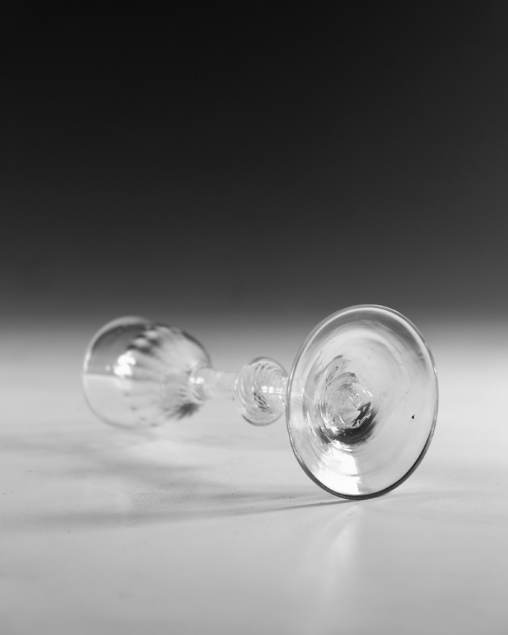 An 18th-century English Georgian clear glass wine glass featuring a funnel bowl and an opaque white twist stem with a central knop. View III