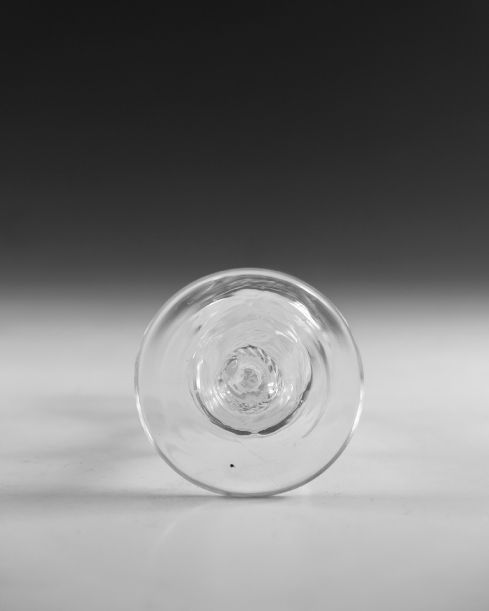 An 18th-century English Georgian clear glass wine glass featuring a funnel bowl and an opaque white twist stem with a central knop. View V