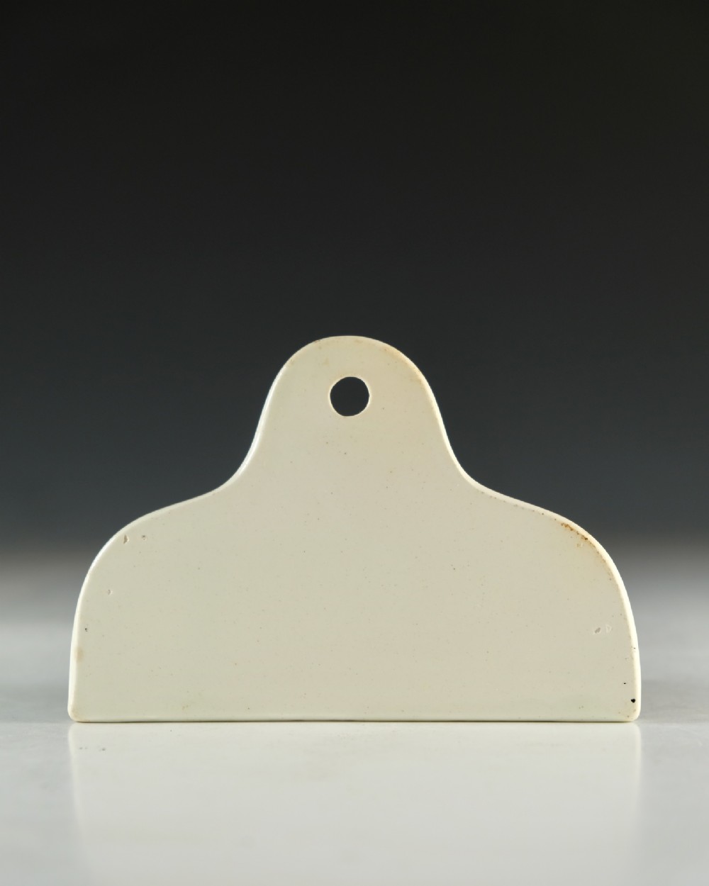A mid-19th century creamware ceramic bin label with a top hole and the word PORT printed in bold black lettering. View III