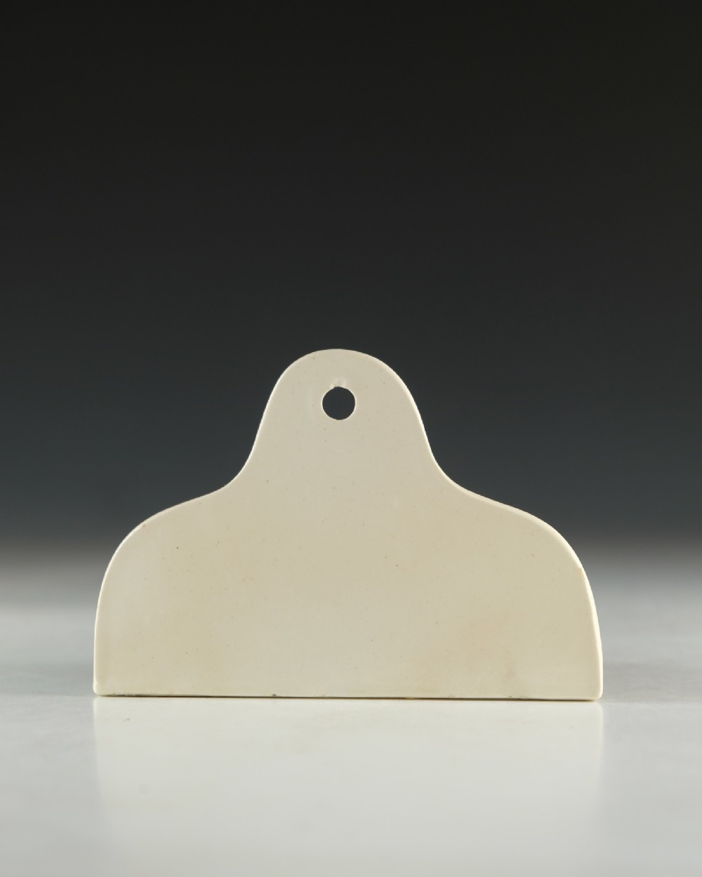 A mid 19th-century cream ceramic wine bin label stamped with the word CLARET in black serif lettering. View III