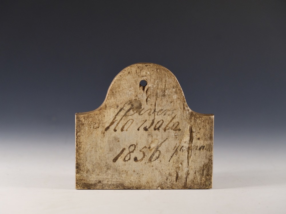 An arched Victorian creamware cellar bin label featuring handwritten dark ink text reading Marsala 1856 with a single hanging hole at the top.
