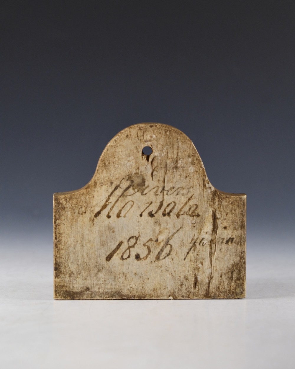 An arched Victorian creamware cellar bin label featuring handwritten dark ink text reading Marsala 1856 with a single hanging hole at the top. View II