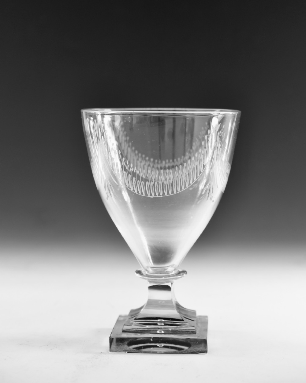 A Georgian clear glass rummer featuring an engraved festoon bowl on a square mould-pressed pedestal base. View II