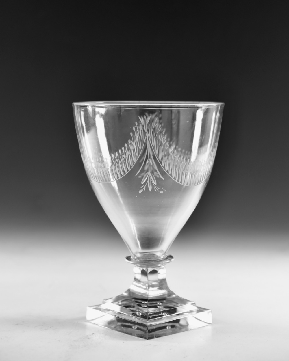 A Georgian clear glass rummer featuring an engraved festoon bowl on a square mould-pressed pedestal base. View III