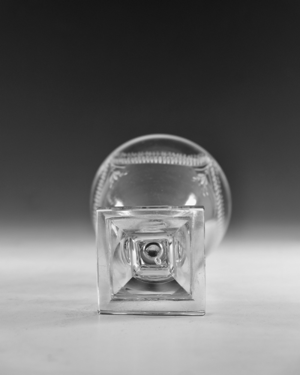 A Georgian clear glass rummer featuring an engraved festoon bowl on a square mould-pressed pedestal base. View VI