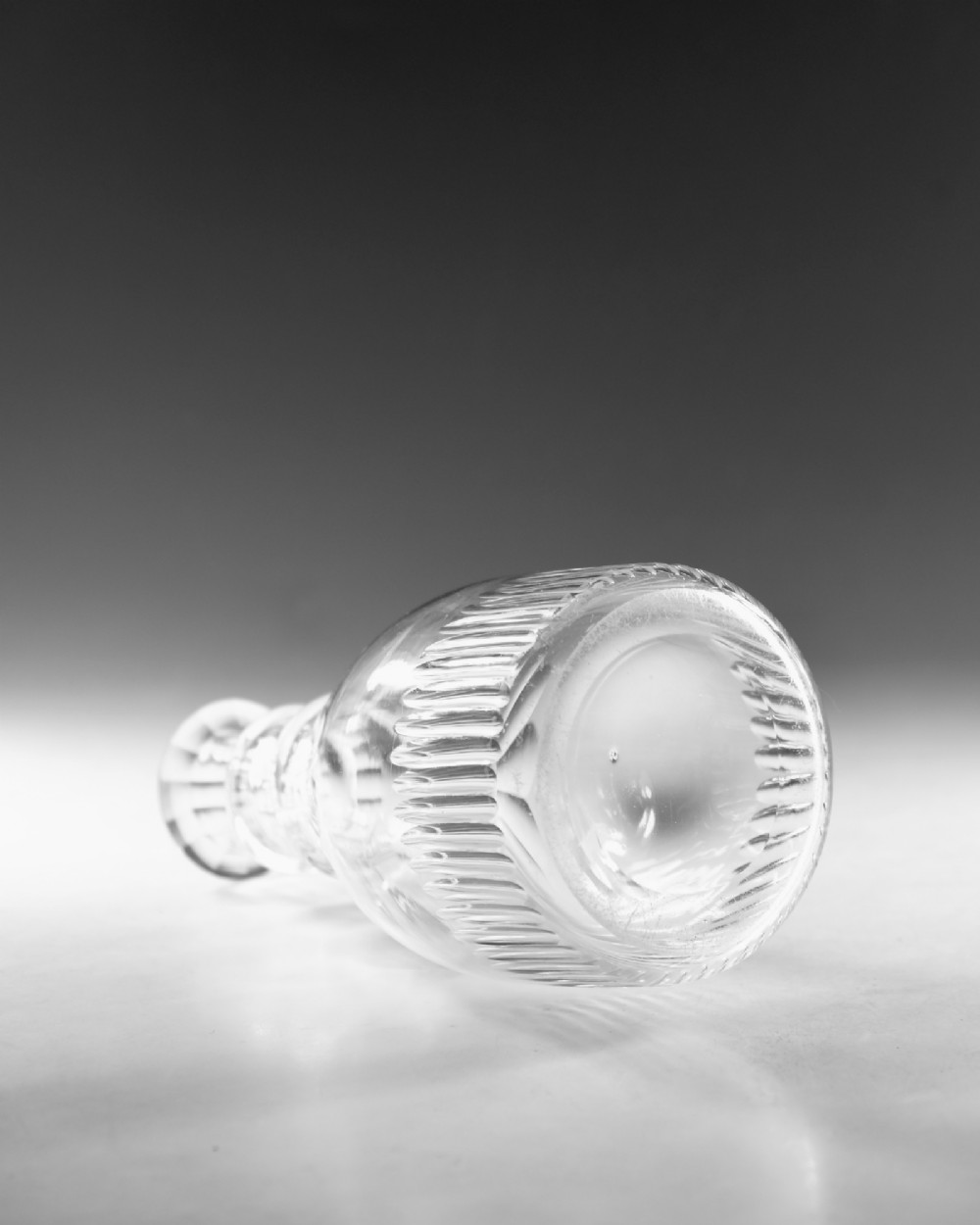 A clear Georgian cut-glass carafe featuring applied neck rings, petal cuts around the shoulder, and vertical fluting on the base. View III