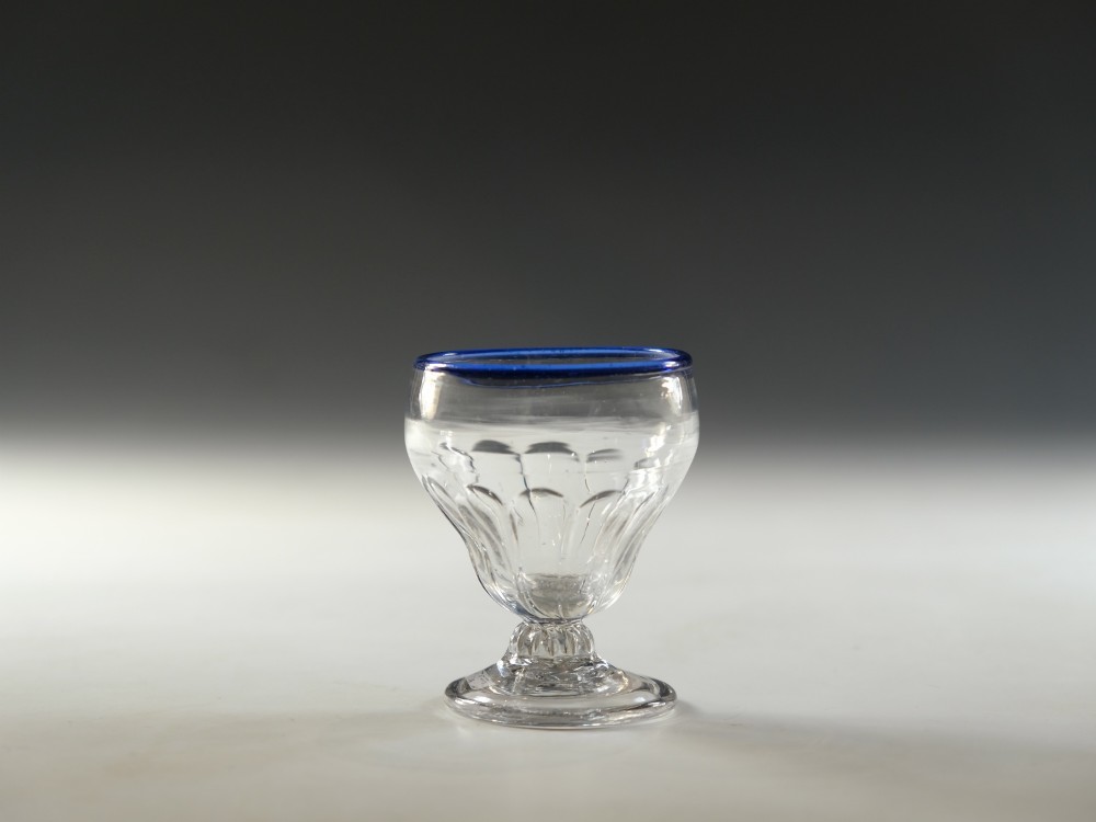 An 18th-century clear lead glass bonnet glass featuring a hand-applied cobalt blue rim, a honeycomb-moulded cup bowl, and a circular flat foot. View III