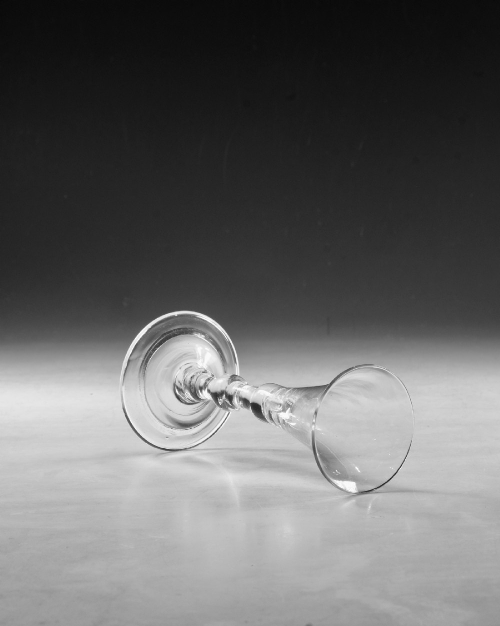 A clear Georgian lead glass vessel featuring a flared trumpet bowl, a central knapped stem, and a circular conical foot. View IV