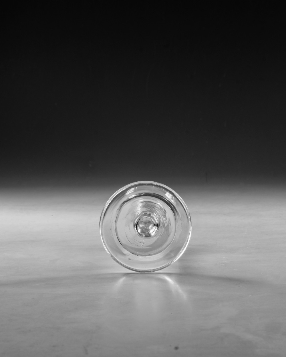 A clear Georgian lead glass vessel featuring a flared trumpet bowl, a central knapped stem, and a circular conical foot. View V