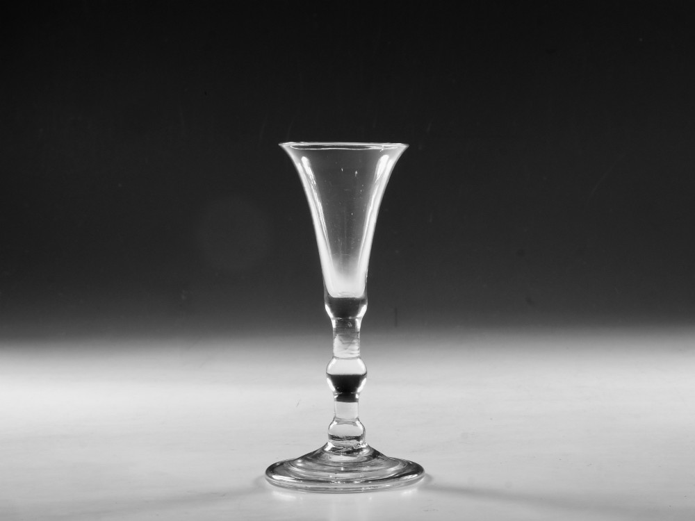 A clear Georgian lead glass vessel featuring a flared trumpet bowl, a central knapped stem, and a circular conical foot. View VI