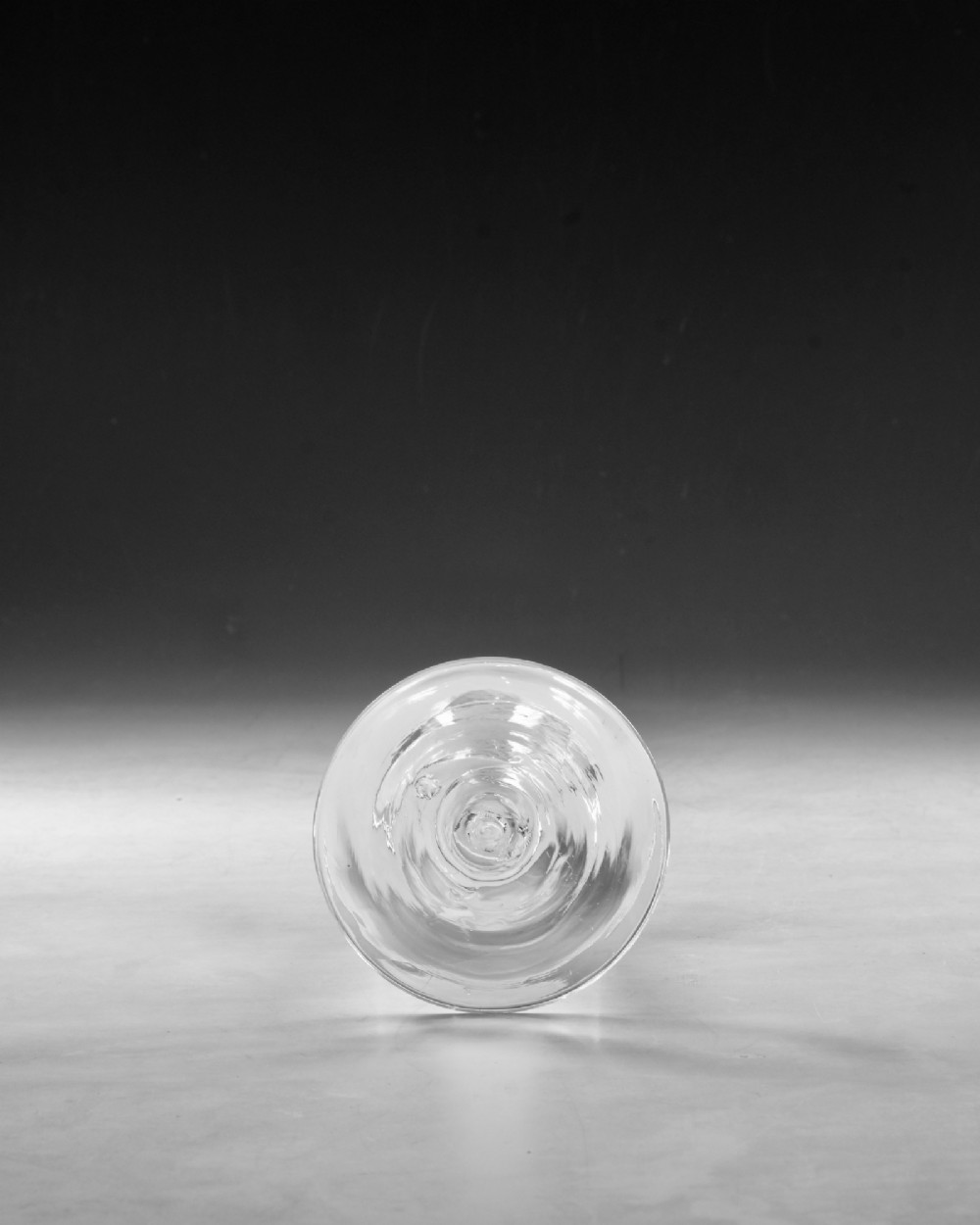 A Georgian clear lead crystal wine glass featuring a bell-shaped bowl, a stem with an internal white opaque twist pattern, and a conical foot. View V