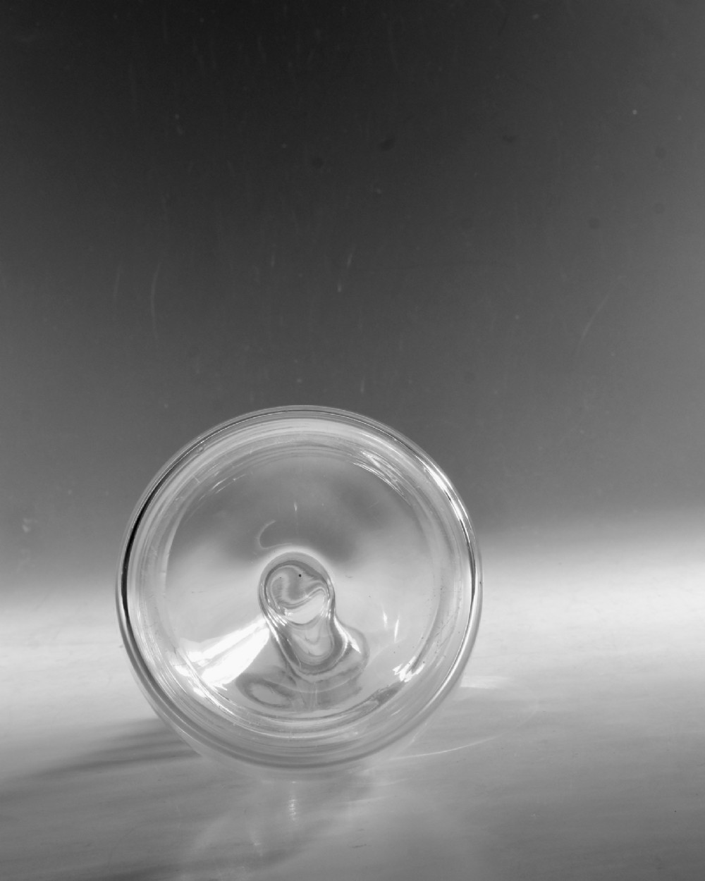 A clear Georgian glass decanter featuring three applied neck rings and a flat circular stopper. View VI