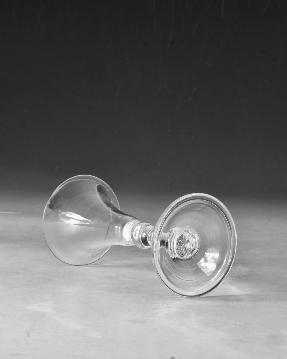 A mid-18th century clear Georgian glass featuring a flared trumpet bowl, a knopped stem, and a broad circular foot. View III